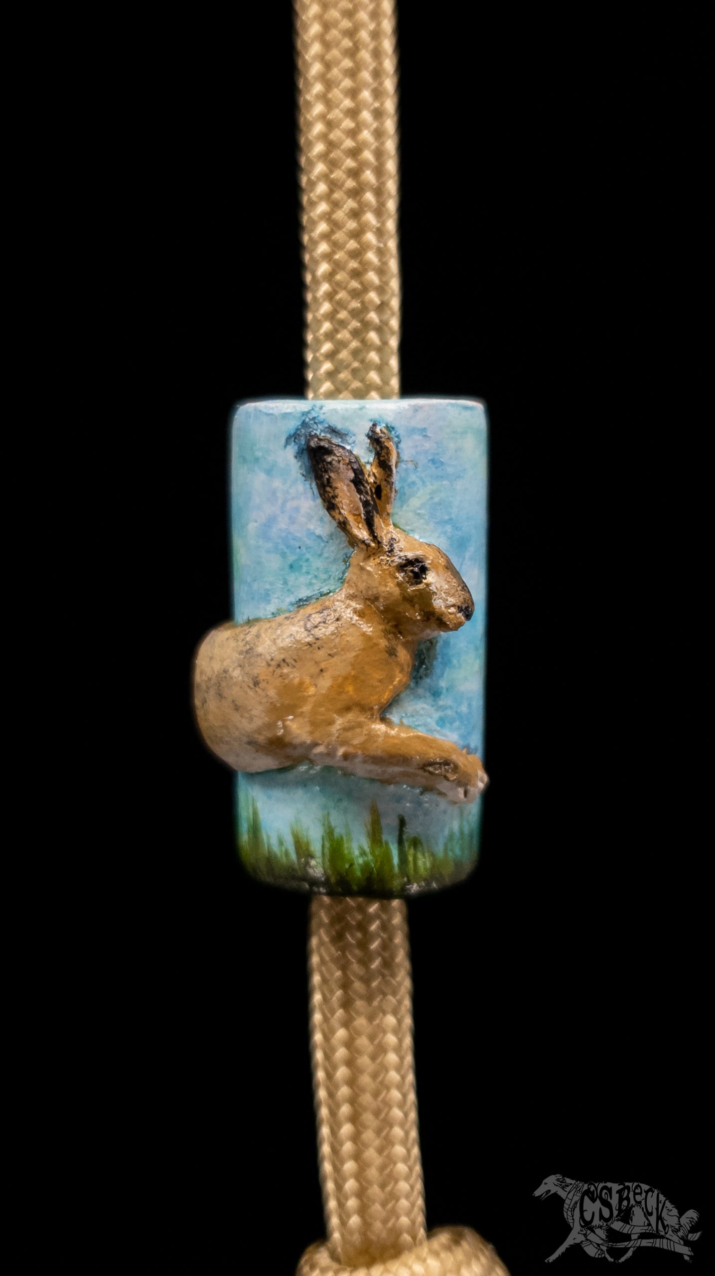 A polymer clay bead with a jackrabbit that I sculpted and painted